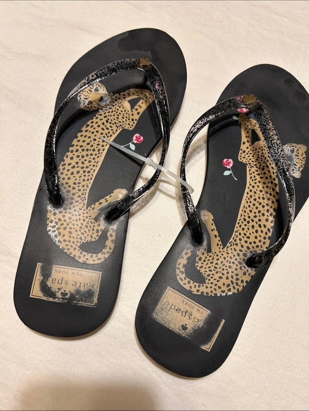 kate spade Black Leopard Print Flip Flop Sandals with Pink Floral Accent